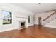 Bright living room boasts hardwood floors, a fireplace, and views of the front yard at 560 Bosphorous Ave, Tampa, FL 33606