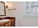 Elegant powder room with classic fixtures, wooden vanity, and ample natural light at 560 Bosphorous Ave, Tampa, FL 33606