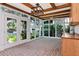 Bright sunroom with brick floors, large windows, and a cozy sink area at 560 Bosphorous Ave, Tampa, FL 33606