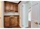 Charming wet bar area with wood cabinetry, sink, and access to hallway at 560 Bosphorous Ave, Tampa, FL 33606