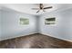 Spacious bedroom featuring hardwood floors, large windows, and ceiling fan at 5860 99Th N Ave, Pinellas Park, FL 33782