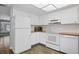 Bright kitchen featuring white cabinets and appliances, and a view of a backyard at 5860 99Th N Ave, Pinellas Park, FL 33782
