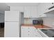 Bright kitchen featuring white cabinets and appliances at 5860 99Th N Ave, Pinellas Park, FL 33782