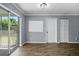 Living room featuring wood-look floors and sliding glass doors at 5860 99Th N Ave, Pinellas Park, FL 33782