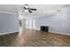 Spacious living room featuring ceiling fan, hardwood floors, light grey walls, and white trim at 5860 99Th N Ave, Pinellas Park, FL 33782