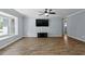 Bright living room with hardwood floors, grey walls, ceiling fan, and large bay window at 5860 99Th N Ave, Pinellas Park, FL 33782