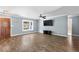 Living room with hardwood floors, light grey walls, white trim, ceiling fan, and natural light at 5860 99Th N Ave, Pinellas Park, FL 33782