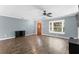 Living room with a wood front door, natural light, hardwood floors, and grey painted walls at 5860 99Th N Ave, Pinellas Park, FL 33782