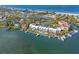 Beautiful aerial shot showcases waterfront condos with boat docks, tennis courts, and a pool at 615 Dream Island Pl # 210, Longboat Key, FL 34228