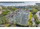 Aerial view of tennis and pickleball courts, surrounded by lush landscaping and convenient parking at 615 Dream Island Pl # 210, Longboat Key, FL 34228