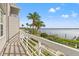 Wide balcony offers stunning views of the water, marina, and tropical foliage at 615 Dream Island Pl # 210, Longboat Key, FL 34228