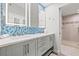 Elegant bathroom features double vanity, blue mosaic tiles, and spacious walk-in shower at 615 Dream Island Pl # 210, Longboat Key, FL 34228