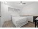 Bright bedroom featuring shiplap accent wall, wood-look floors, and a convenient beverage fridge at 615 Dream Island Pl # 210, Longboat Key, FL 34228