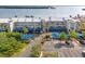 Condo exterior featuring covered parking, lush landscaping and well-maintained grounds at 615 Dream Island Pl # 210, Longboat Key, FL 34228