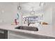 Bright kitchen features quartz counters, stainless sink, and an open view to the living area at 615 Dream Island Pl # 210, Longboat Key, FL 34228