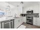 Modern kitchen features stainless steel appliances, white cabinets, and an open layout at 615 Dream Island Pl # 210, Longboat Key, FL 34228