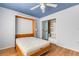 Bright bedroom featuring a Murphy bed and hardwood floors, complete with a spacious closet and convenient bedside lamps at 638 La Jolla Ave, Sun City Center, FL 33573