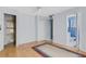 Bedroom with hardwood flooring, ceiling fan, closet, ensuite bath and view into the bathroom at 638 La Jolla Ave, Sun City Center, FL 33573