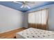 Bright bedroom with a Murphy bed and hardwood floors, featuring a ceiling fan and window with bright natural light at 638 La Jolla Ave, Sun City Center, FL 33573