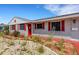 Charming front exterior of a home with a red door, red shutters, and well-maintained landscaping at 638 La Jolla Ave, Sun City Center, FL 33573