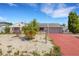 Charming single-story home featuring a cozy facade, red-painted driveway, and xeriscaped yard with a palm tree at 638 La Jolla Ave, Sun City Center, FL 33573