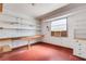 Finished garage with built-in shelves, storage cabinets, a workbench, and a window with an air conditioner at 638 La Jolla Ave, Sun City Center, FL 33573