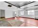 This large garage includes a red-stained floor, with shelving and a bright white wall at 638 La Jolla Ave, Sun City Center, FL 33573