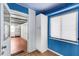 Doorway between kitchen and garage, featuring white cabinets, natural light from window, and a view into the garage at 638 La Jolla Ave, Sun City Center, FL 33573