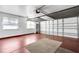 This large garage includes a red-stained floor, with shelving and a bright white wall at 638 La Jolla Ave, Sun City Center, FL 33573