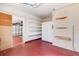 A large garage with epoxy flooring, white walls, storage shelves, cabinets and fire extinguisher at 638 La Jolla Ave, Sun City Center, FL 33573