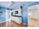 Kitchen featuring white cabinets and black appliances with an open doorway to the living room at 638 La Jolla Ave, Sun City Center, FL 33573