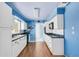 Kitchen view featuring white cabinets and black appliances at 638 La Jolla Ave, Sun City Center, FL 33573