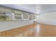 Spacious living room with hardwood floors, abundant natural light, and multiple windows offering a bright and airy feel at 638 La Jolla Ave, Sun City Center, FL 33573