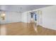 Large living area with hardwood floors, featuring an open doorway and ample space for furniture arrangement at 638 La Jolla Ave, Sun City Center, FL 33573