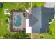 Aerial view of house with metal roof, caged pool, and lush green yard at 7725 235Th E St, Myakka City, FL 34251