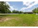 Large backyard with lush lawn and white picket fence, offering ample space for recreation and privacy in a residential setting at 7725 235Th E St, Myakka City, FL 34251