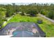 Expansive backyard with screened pool, trampoline, and lush green lawn offers great outdoor space at 7725 235Th E St, Myakka City, FL 34251