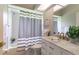 Bathroom featuring vanity with marble countertops, gold hardware, and shower-tub combo at 7725 235Th E St, Myakka City, FL 34251