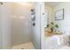 Modern bathroom showcasing a gray tiled shower, a standalone tub, and bright natural light at 7725 235Th E St, Myakka City, FL 34251