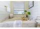 Bathroom featuring a marble-encased soaking tub, shiplap walls, window and decorative accents at 7725 235Th E St, Myakka City, FL 34251