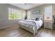 Bright bedroom with white furniture, a ceiling fan, and laminate flooring at 7725 235Th E St, Myakka City, FL 34251