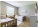 Cozy bedroom with hardwood floors, neutral paint, two beds, and a ceiling fan at 7725 235Th E St, Myakka City, FL 34251