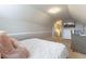 Bedroom with angled ceilings, neutral paint, bed and television at 7725 235Th E St, Myakka City, FL 34251