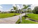 Paved driveway leads to a pristine white home framed by palm trees at 7725 235Th E St, Myakka City, FL 34251