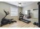Well-lit home gym with cardio equipment, a large mirror, and wood flooring at 7725 235Th E St, Myakka City, FL 34251