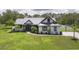 Charming home boasts a metal roof, verdant lawn, and a basketball hoop at 7725 235Th E St, Myakka City, FL 34251