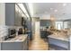 Open concept kitchen with gray cabinets, stainless appliances, and granite countertops at 7725 235Th E St, Myakka City, FL 34251