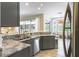 Kitchen with a stainless steel dishwasher and sink looking into the sunroom at 7725 235Th E St, Myakka City, FL 34251