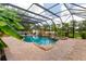 Beautiful pool area featuring a rock waterfall, spa and lush landscaping, all enclosed in a screened lanai for year-round enjoyment at 7725 235Th E St, Myakka City, FL 34251