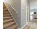 Hallway with view of the staircase leading to the 2nd floor of the home with wood floors at 7725 235Th E St, Myakka City, FL 34251